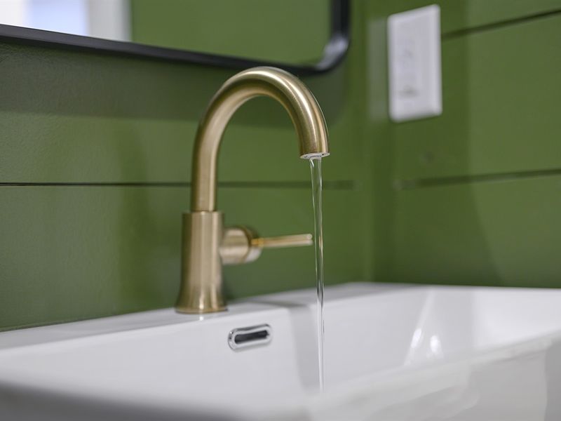 Wash away in this vibrant oasis! Let the calming green hues of this bathroom revitalize your daily rituals.