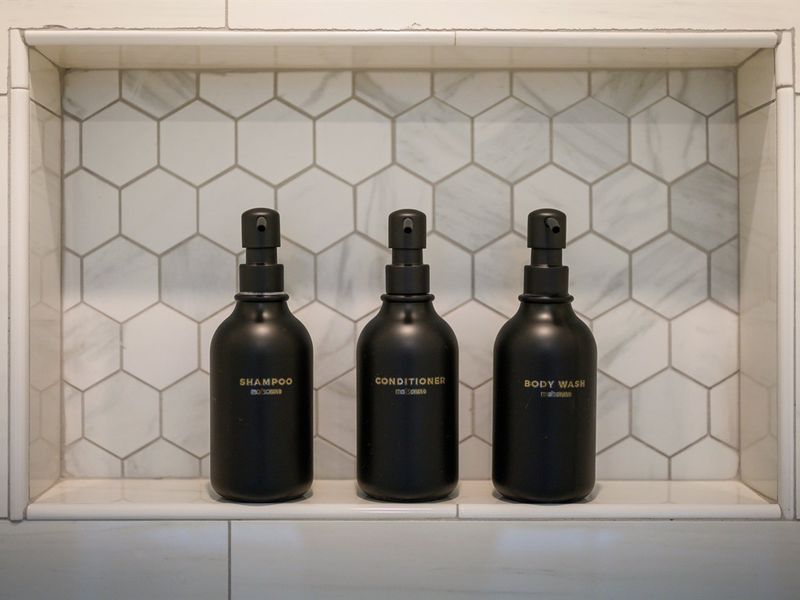 A built-in shower niche keeps premium toiletries neatly organized for a clean, spa-like experience.