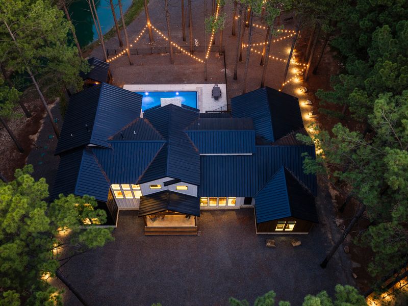 Aerial view of Bear Lake Lodge, showcasing its modern design surrounded by towering pines