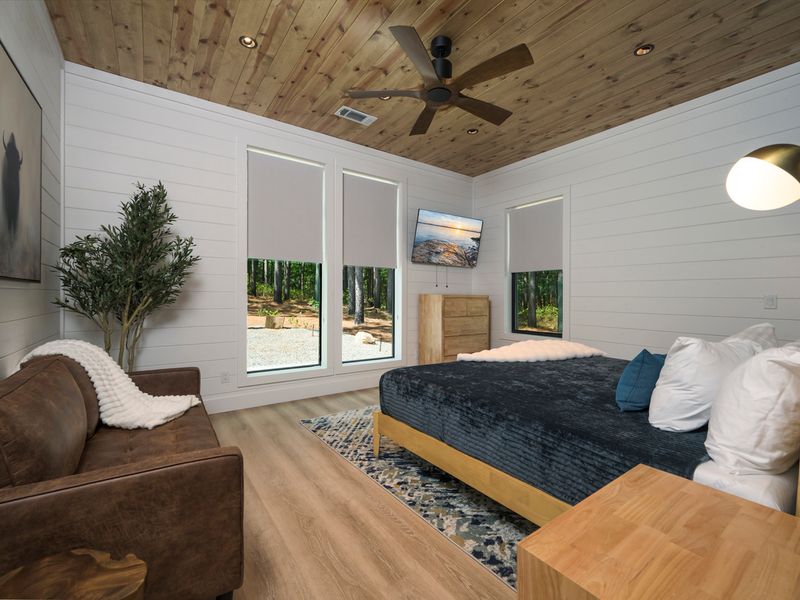 Warm and sophisticated king bedroom featuring a dramatic wood-slat accent wall and plush bedding.