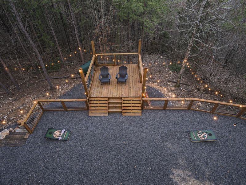 String lights add a warm, inviting glow to the wooded retreat.