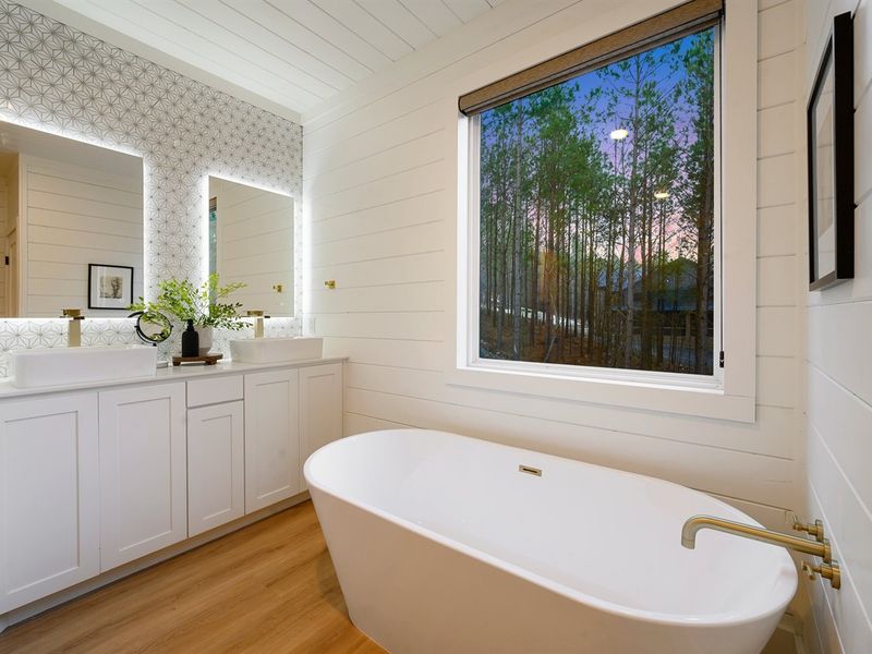 Enjoy peaceful forest views from the soaking tub for the ultimate unwind.