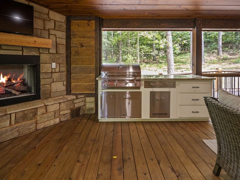 "Warm conversations spark by the glow of our inviting outdoor fireplace."