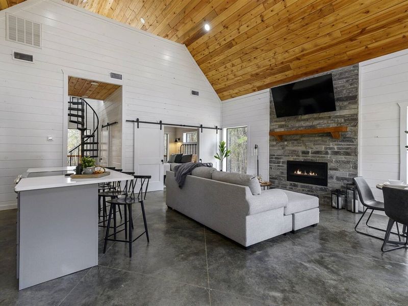 Warm wood tones, shiplap walls, and granite countertops create a modern living space