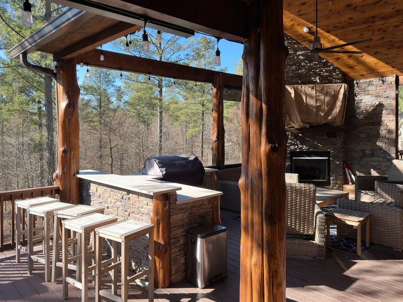 Experience outdoor luxury on our back deck: unwind by the cozy fireplace, catch the game on TV, and sizzle up delicious meals on the grill, all in one captivating space