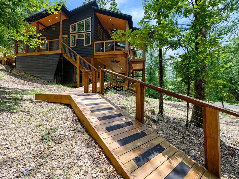 Forest Escape: Follow the wooden walkway through the tranquil woods to your private luxury cabin.