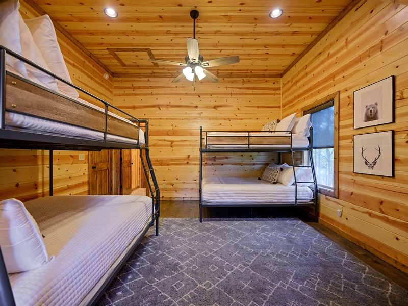 "Cozy nights in the bunk room: Perfect for stories and dreams under the rustic beams."