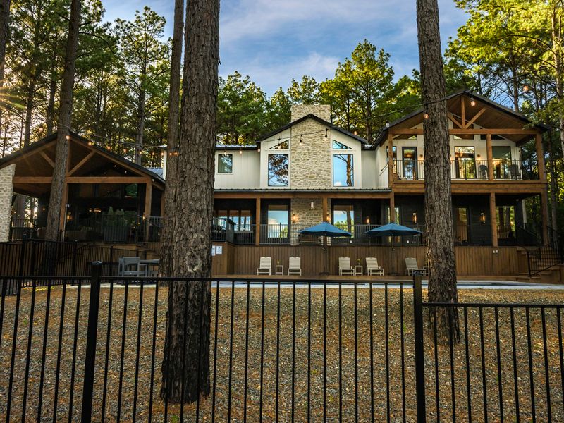 A beautiful view of the retreat surrounded by towering pines and peaceful natural scenery.