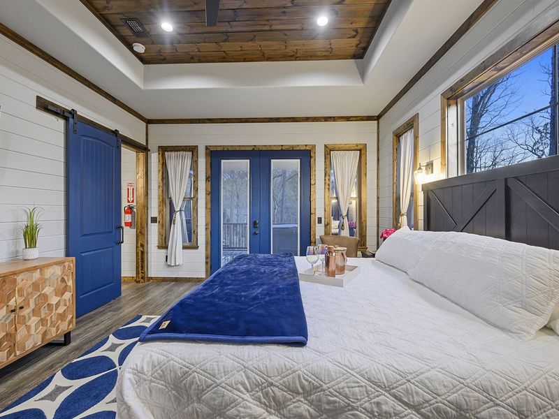 Indulge in luxury in the primary bedroom, featuring a king-sized bed and a private ensuite bathroom with a romantic claw-foot tub.