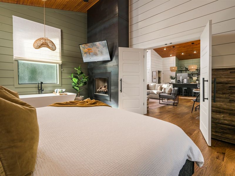 Your private retreat awaits—soft linens, warm wood tones, and seamless flow into the heart of the cabin. Come stay with us