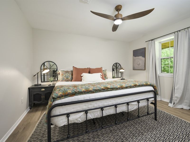 "Sink into comfort with plush bedding and calming decor in Master  Bedroom 1."