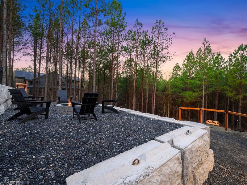 Gather around the firepit under the evening sky and enjoy cozy nights surrounded by the woods.