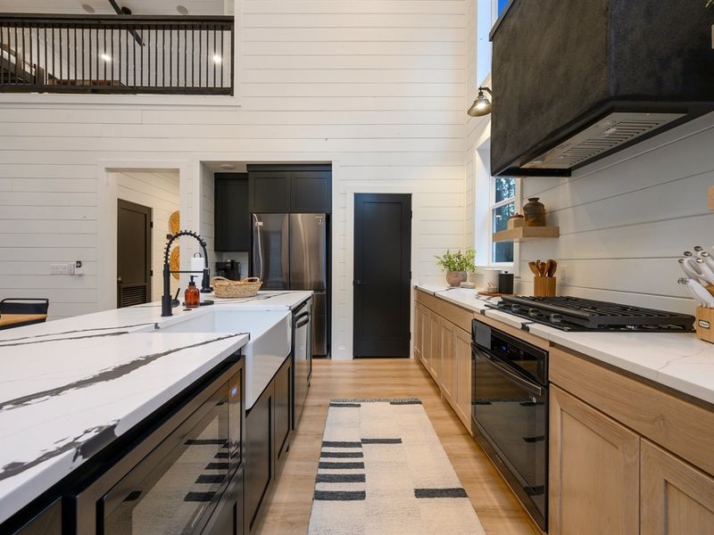 Spacious and light-filled, the kitchen offers ample prep space and effortless entertaining.