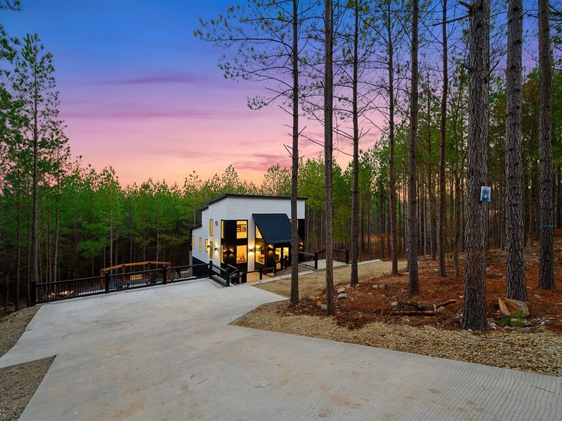 Modern architecture meets tranquil woodland surroundings.