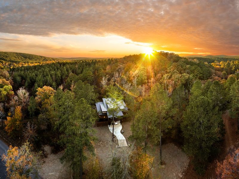 Surrounded by forest and glowing at sunset, this is where your quiet cabin getaway begins