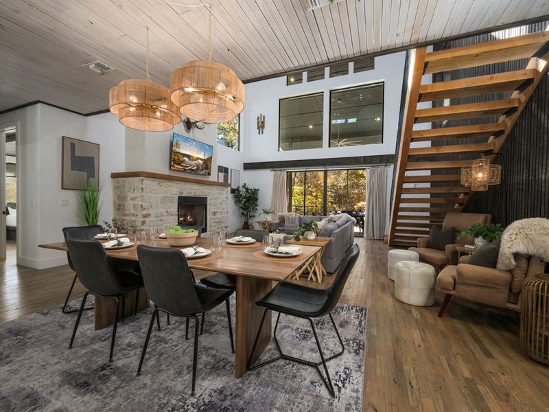Experience luxury cabin living in Hochatown with vaulted ceilings, modern design, and a cozy stone fireplace.