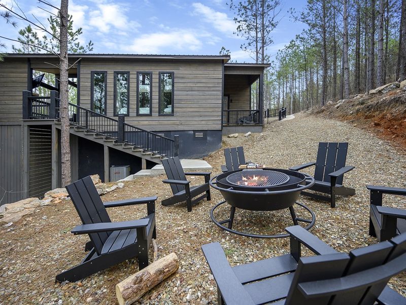 Embrace the wild serenity around you, as you relax by the fire pit by our cozy cabin in the woods 🔥🍃