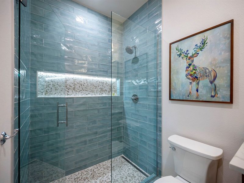 A soothing walk-in shower with glowing niche lighting and nature-inspired touches. 🌿💧