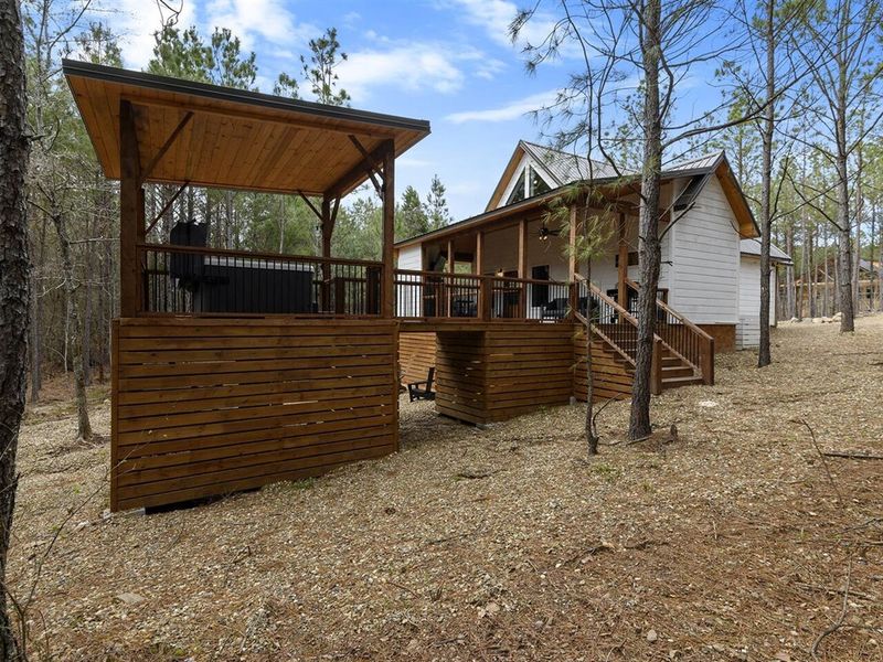 Discover the joy of outdoor living, where the deck beckons with its cozy fireplace and inviting hot tub