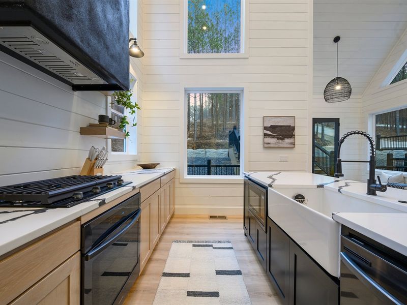 The oversized farmhouse sink and high-end appliances make cooking both stylish and effortless.