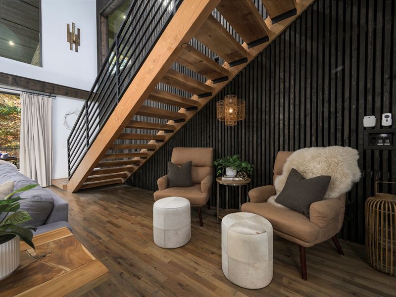 Thoughtfully designed lounge space beneath the staircase, blending modern architecture with cabin warmth