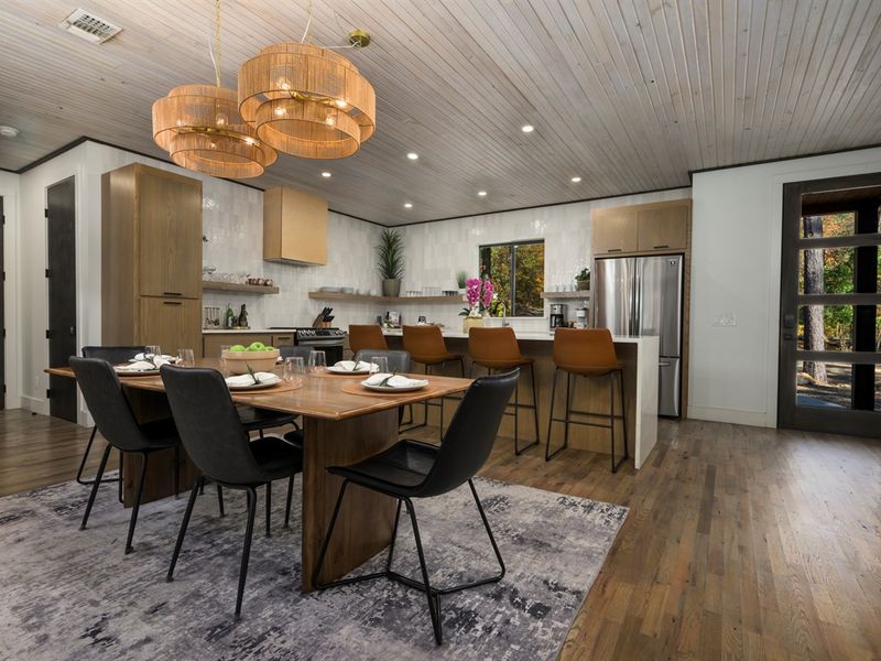 Open-concept kitchen and dining area in our luxury Broken Bow cabin, perfect for family meals and entertaining
