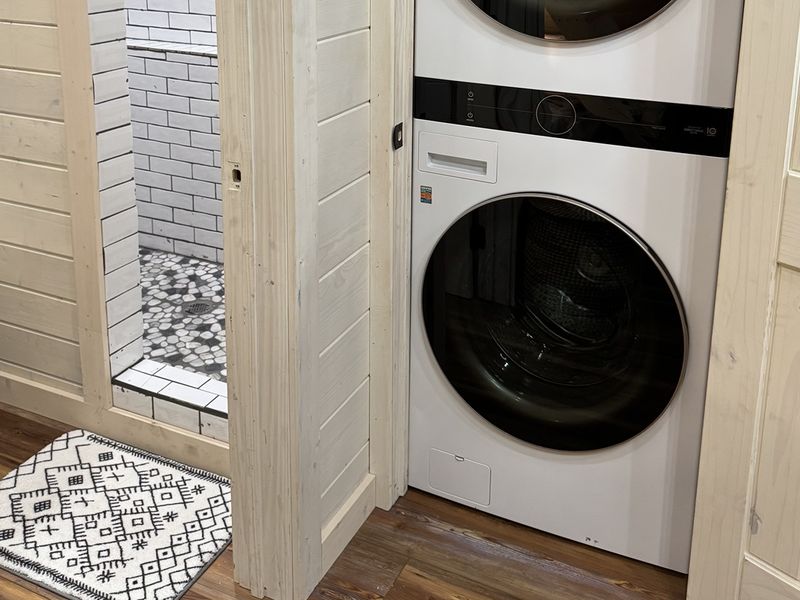 A contemporary and inviting bathroom with washer and dryer.