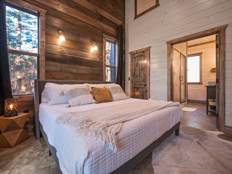Soft linens and warm cabin touches create a peaceful private retreat.