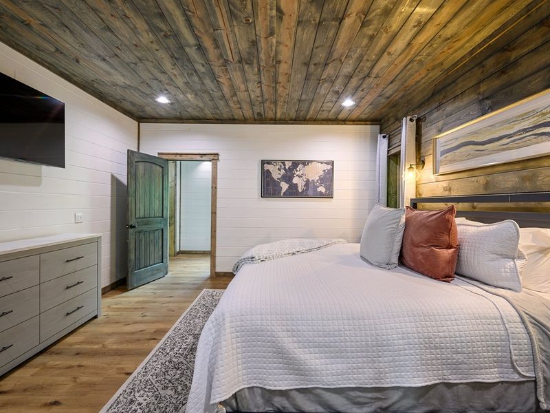 King Suite One features a cozy king-size bed, a 55-inch TV, and luxurious bedding for a dreamy night's sleep