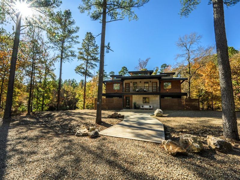 Luxury Broken Bow cabin nestled on a private wooded lot, featuring modern design and peaceful forest views
