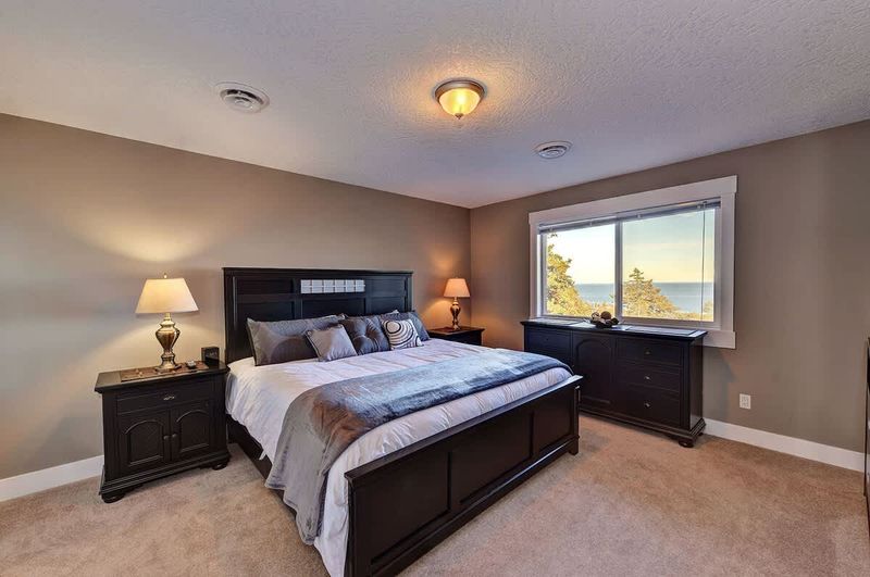Second master bedroom suite with king size bed, private ensuite and ocean views. 
