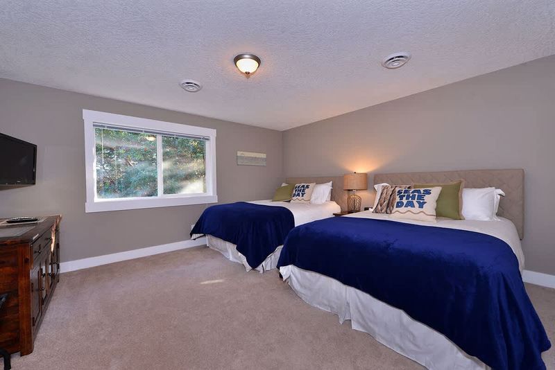 Fourth bedroom with two queen size beds has access to a four piece bathroom which is also shared with the third bedroom.