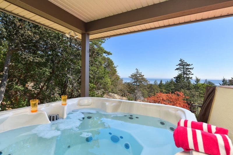 Hot tub overlooks the Juan de Fuca Strait and Olympic Mountains.