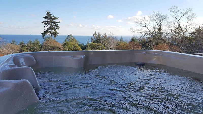 Hot tub overlooks the Juan de Fuca Strait and Olympic Mountains.