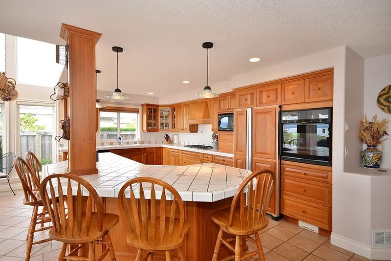 A gourmet kitchen with huge island and custom cherry cabinetry.