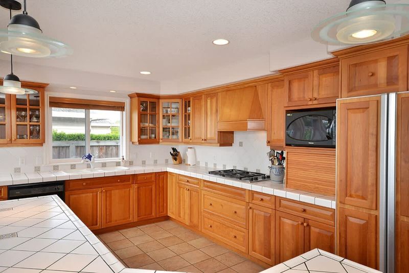 The gourmet kitchen with custom cherry cabinetry