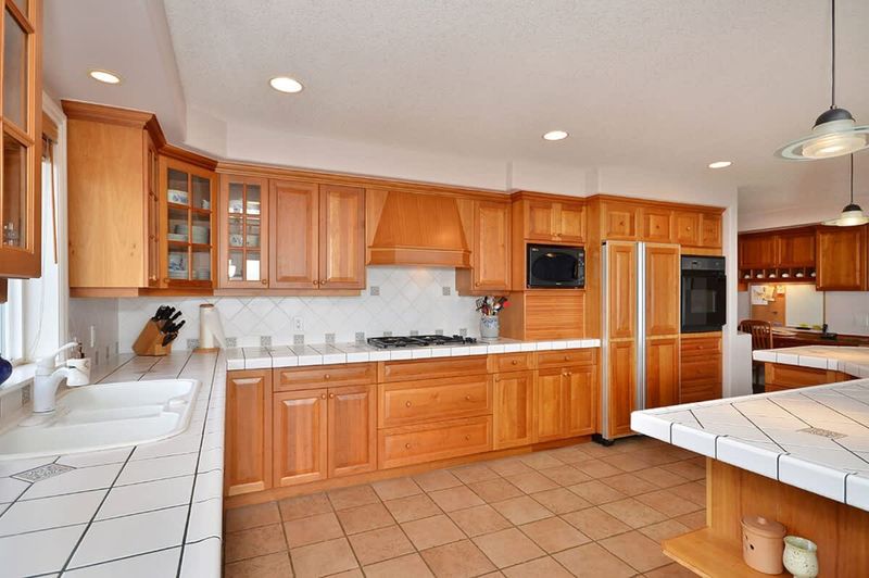 The gourmet kitchen with custom cherry cabinetry