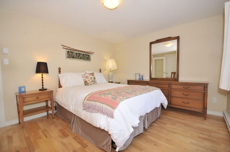 Second bedroom with queen-sized bed and with both ocean and garden views