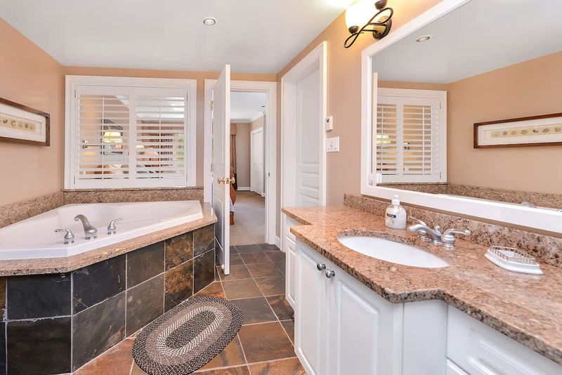 Large and spacious Master bathroom with walk in shower and soaker tub. 
