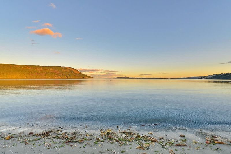 Sandy beach below the house.