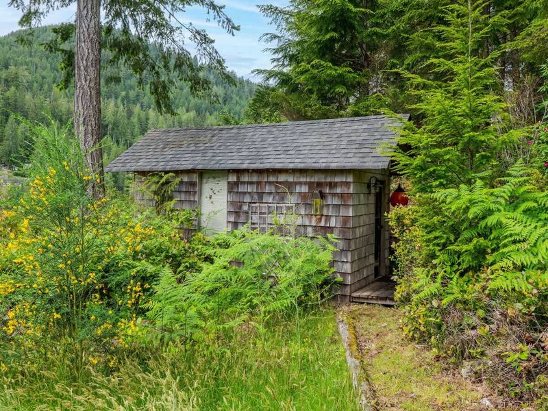 Old hand hewn log shed to admire on the property. 