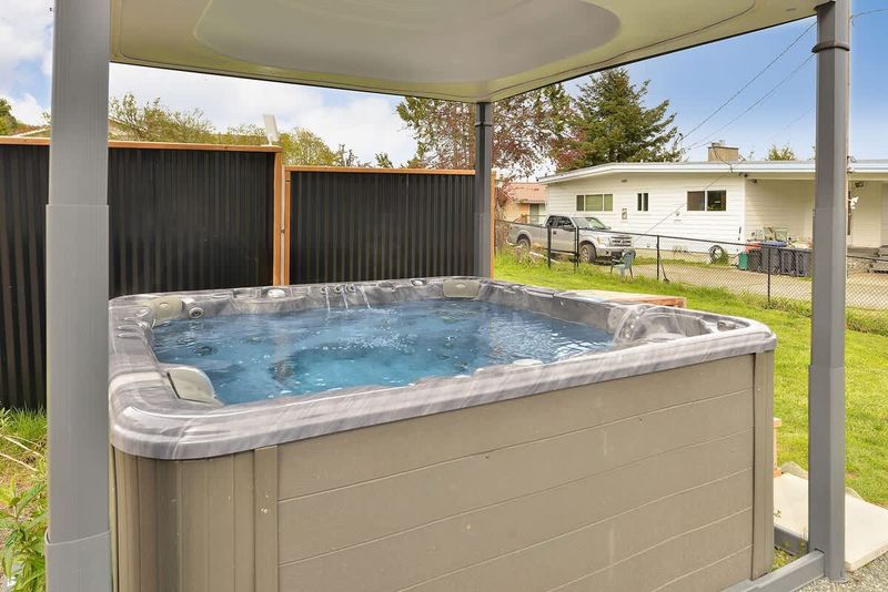 Covered hot tub with automatic top lift.