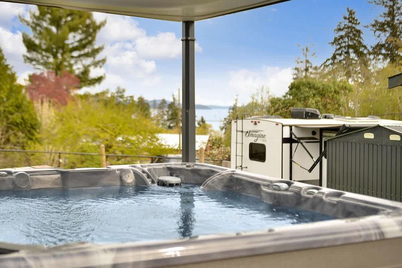 Covered hot tub with automatic top lift.