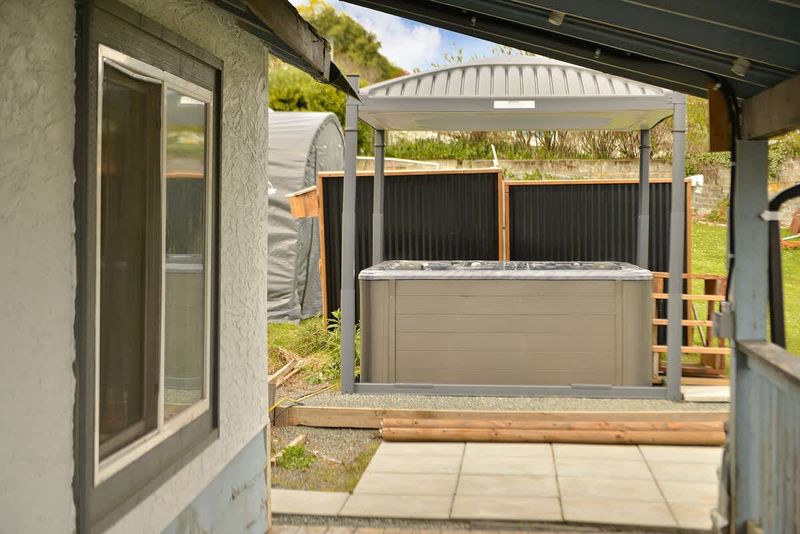 Covered hot tub with automatic top lift.