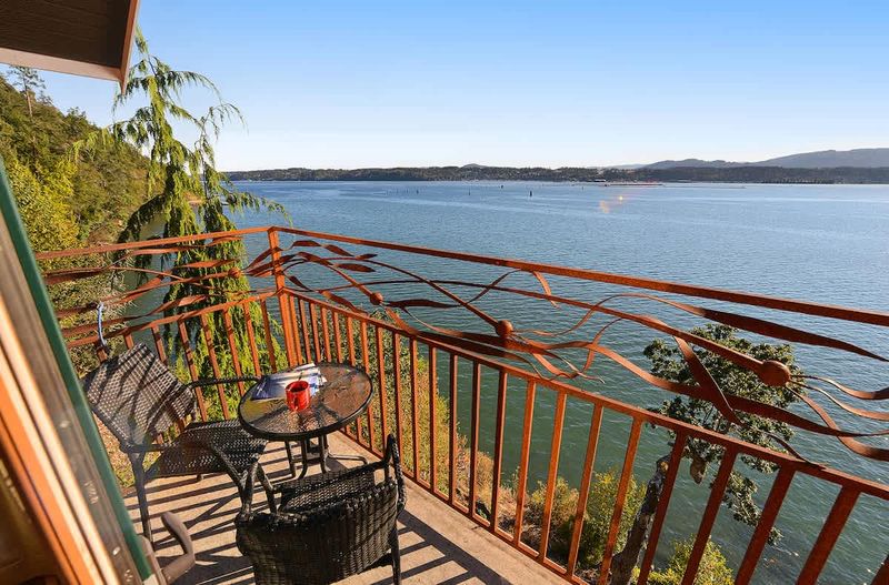Primary bedroom private bay view balcony.