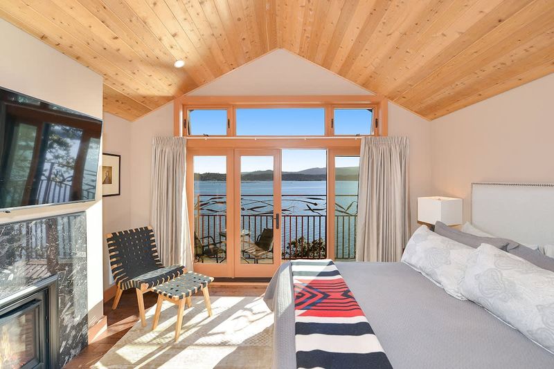 Primary bedroom with private balcony and sweeping bay views.