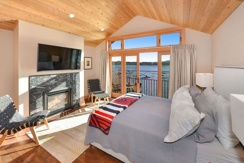 Primary bedroom with private balcony and sweeping bay views.