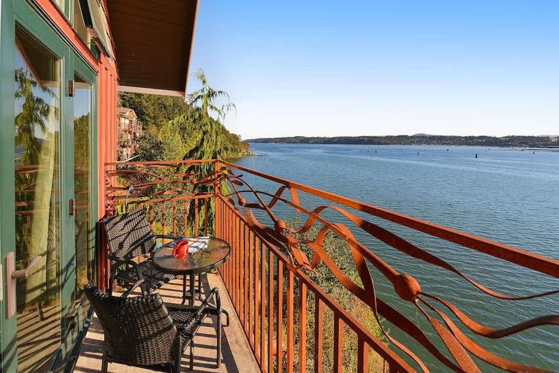 Primary bedroom private bay view balcony.