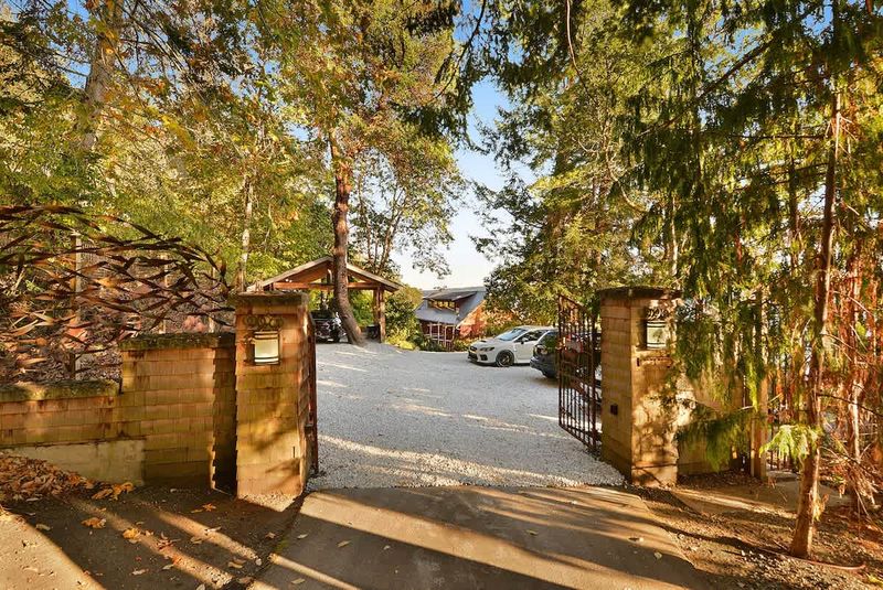 Main gates to the property with secure parking to the right.