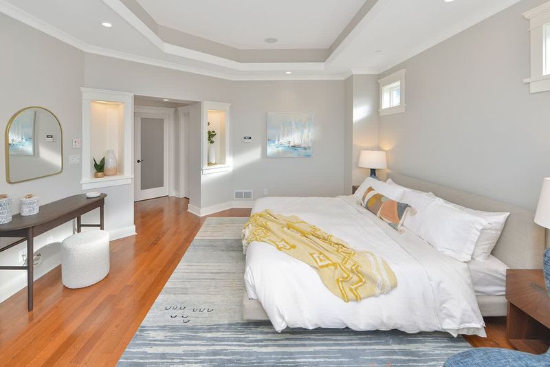 Primary bedroom king bed with private deck access and electric fireplace.